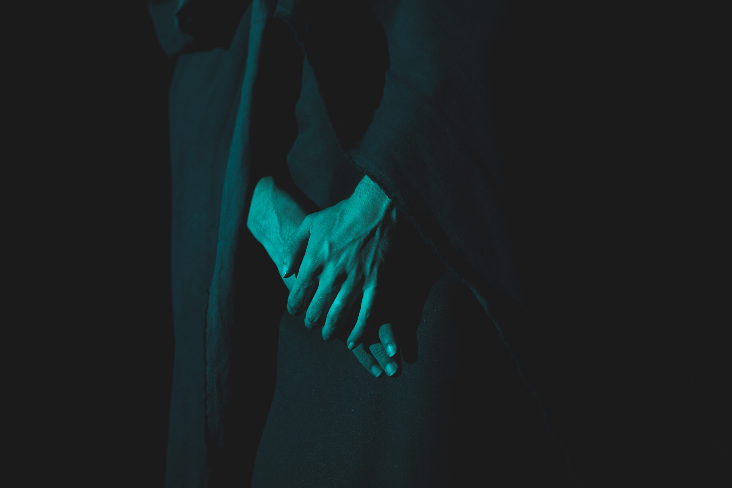 close up hand holding together darkness scaled